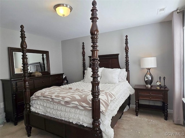 carpeted bedroom with visible vents and baseboards