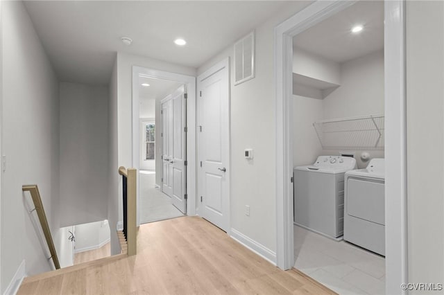 clothes washing area featuring visible vents, light wood-style flooring, washer and clothes dryer, recessed lighting, and laundry area