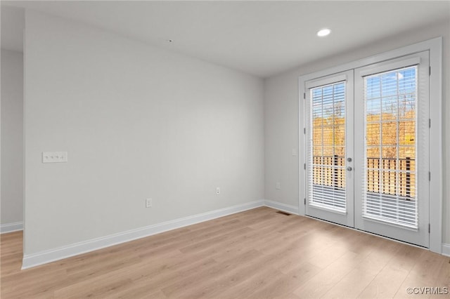 unfurnished room featuring recessed lighting, french doors, baseboards, and light wood-style floors