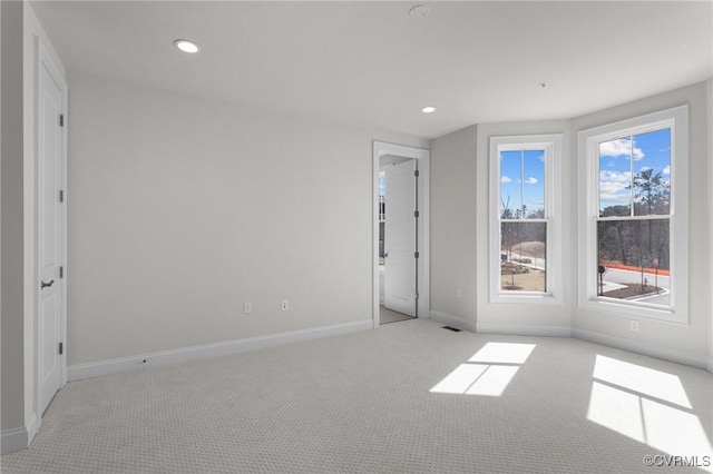 unfurnished room featuring recessed lighting, baseboards, carpet floors, and visible vents