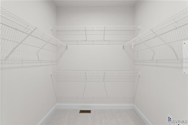 walk in closet with visible vents and carpet floors