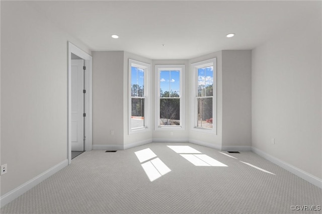 spare room with carpet flooring, recessed lighting, and baseboards