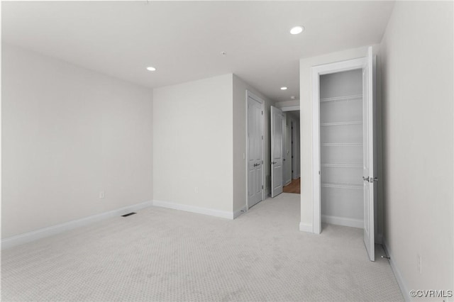 empty room featuring recessed lighting, visible vents, baseboards, and light colored carpet