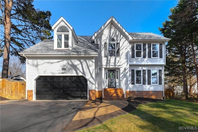 view of front of property featuring an attached garage, driveway, a front lawn, and fence