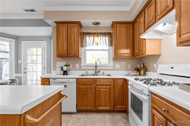 kitchen featuring ornamental molding, a sink, under cabinet range hood, white appliances, and brown cabinetry