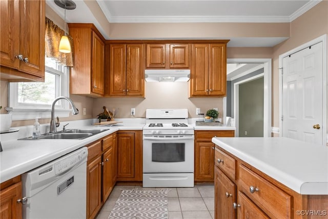 kitchen featuring white appliances, brown cabinetry, under cabinet range hood, and a sink