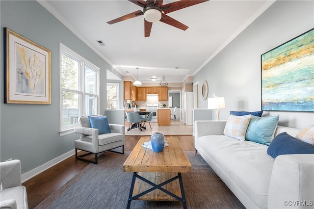 living room featuring light wood-type flooring, baseboards, visible vents, and ornamental molding