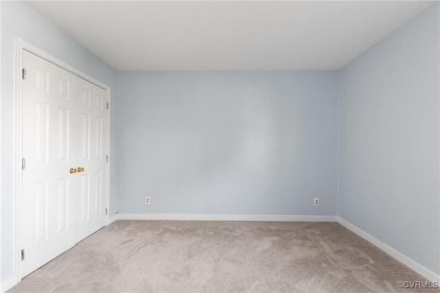 unfurnished bedroom featuring carpet flooring and baseboards