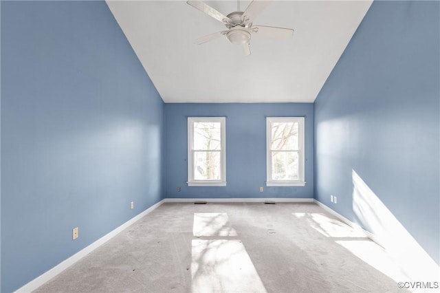 unfurnished room featuring vaulted ceiling, a ceiling fan, baseboards, and carpet floors