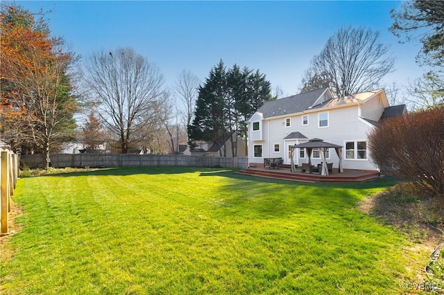 view of yard with a deck, a gazebo, and a fenced backyard