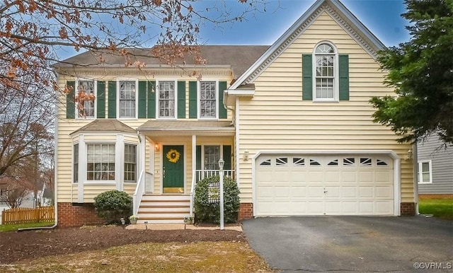 view of front of house with aphalt driveway and a garage