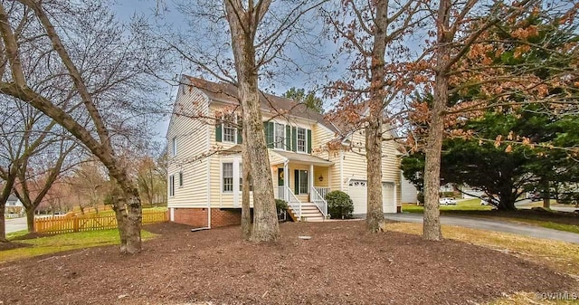 view of front of house featuring driveway and fence