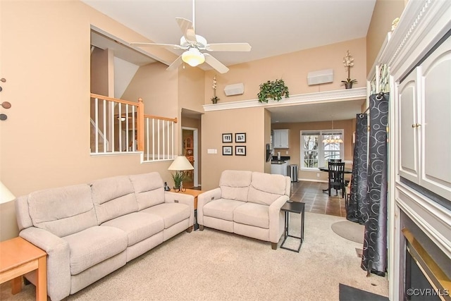 carpeted living area featuring a ceiling fan and vaulted ceiling