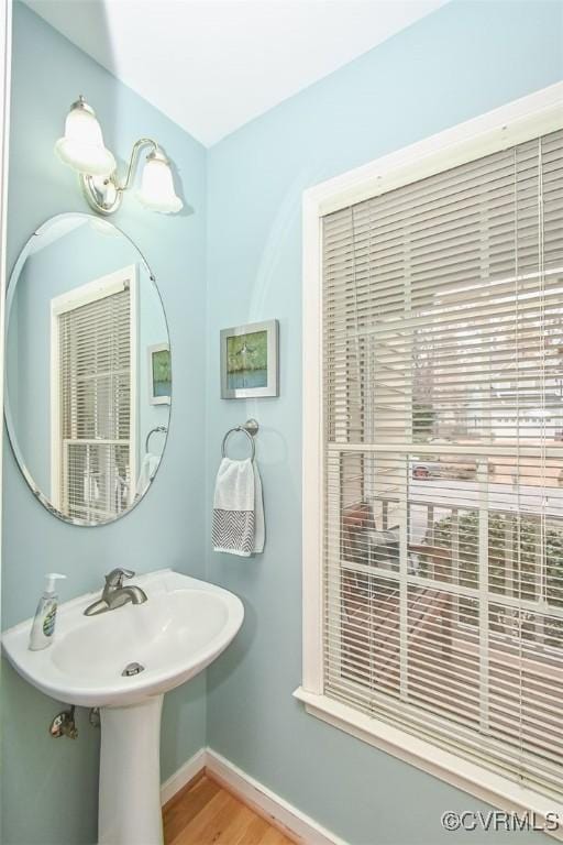 bathroom featuring a sink, baseboards, and wood finished floors