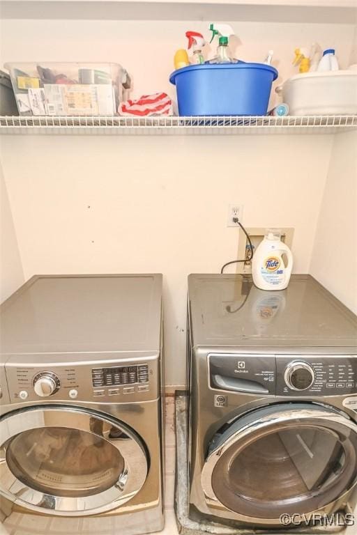 washroom with washing machine and dryer and laundry area