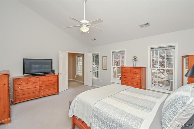 carpeted bedroom featuring lofted ceiling, baseboards, visible vents, and ceiling fan