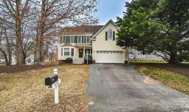 traditional-style home featuring a garage and driveway