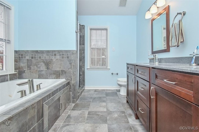 bathroom featuring visible vents, baseboards, toilet, a garden tub, and vanity