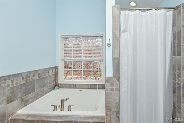 full bathroom featuring a shower with shower curtain and a garden tub