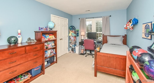 bedroom with visible vents and light carpet