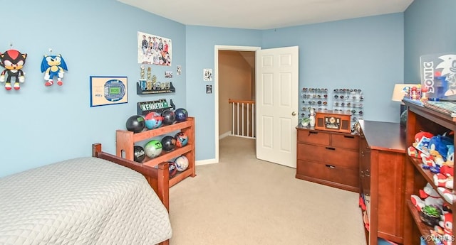 bedroom featuring baseboards and light carpet