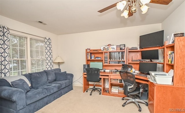 office area featuring carpet, visible vents, and ceiling fan