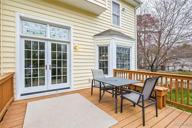 deck with outdoor dining space and french doors