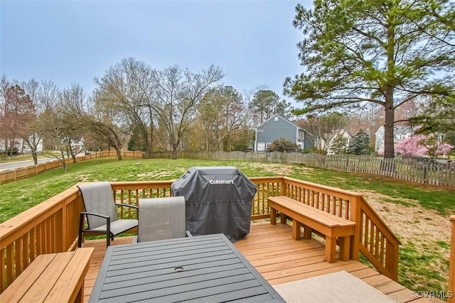 wooden deck featuring outdoor dining space, a fenced backyard, a lawn, and a grill