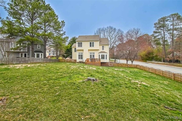 view of yard featuring a wooden deck and fence