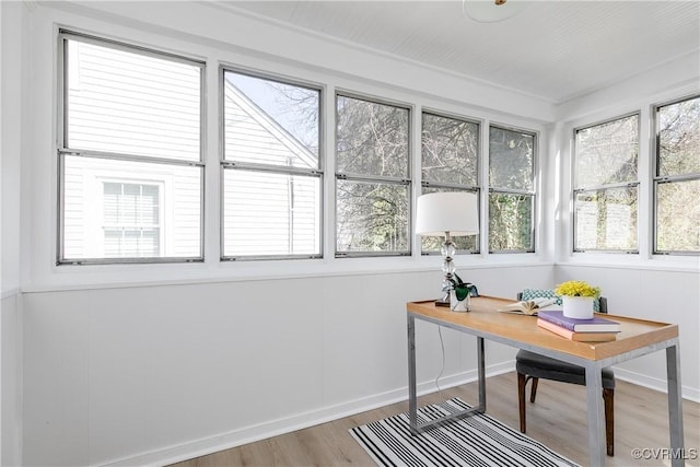 office space with baseboards and wood finished floors