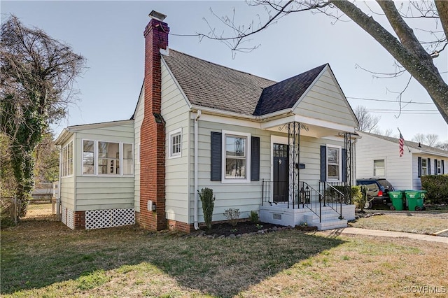 view of front of house with a front yard, fence, a chimney, and crawl space