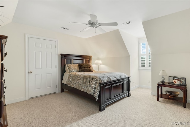 bedroom featuring baseboards, visible vents, light carpet, and lofted ceiling