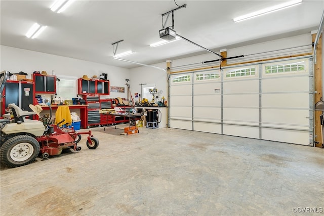 garage with a workshop area and a garage door opener