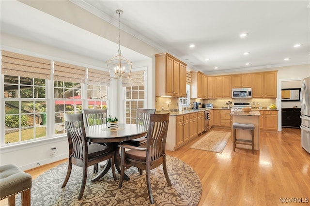 dining room featuring light wood finished floors, crown molding, baseboards, recessed lighting, and a notable chandelier