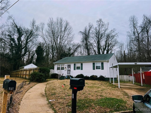 single story home featuring a carport and fence