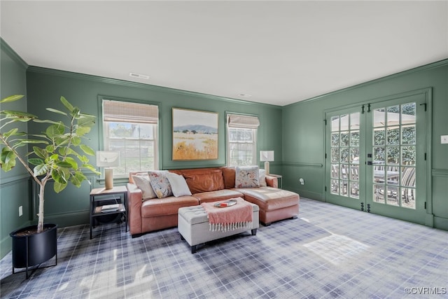 living room featuring crown molding, french doors, and visible vents