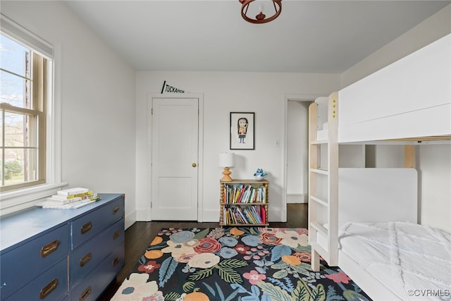 bedroom with dark wood-style floors