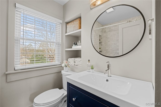 bathroom featuring toilet and vanity