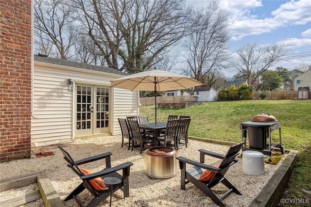 view of patio featuring an outdoor fire pit, an outdoor structure, and fence