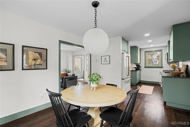 dining area featuring recessed lighting, dark wood-style floors, and baseboards