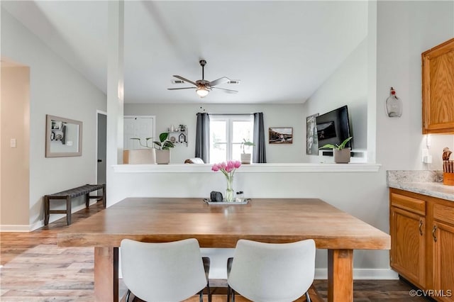 dining room with ceiling fan, visible vents, baseboards, and wood finished floors