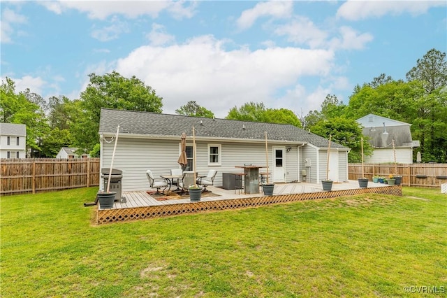 rear view of property with a wooden deck, a yard, central AC unit, and a fenced backyard