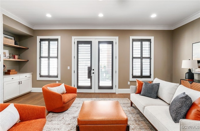 living area with recessed lighting, light wood-style floors, baseboards, and ornamental molding