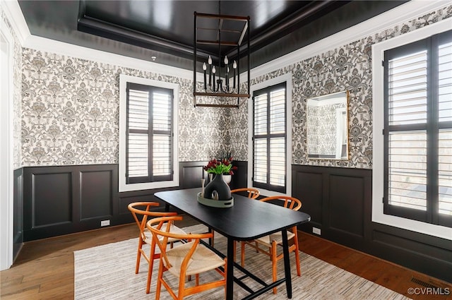 dining room featuring a wealth of natural light, wainscoting, and wallpapered walls