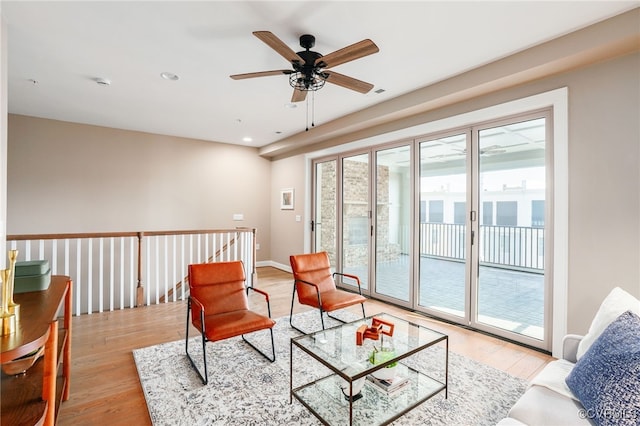 living area featuring recessed lighting, baseboards, light wood-style flooring, and a ceiling fan