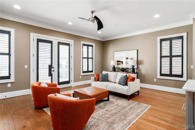 living area with crown molding and light wood-type flooring