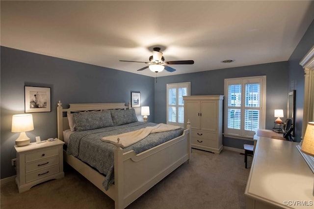 bedroom with visible vents, baseboards, light colored carpet, and ceiling fan