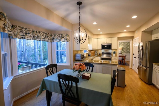 dining space featuring light wood finished floors, a toaster, recessed lighting, and baseboards