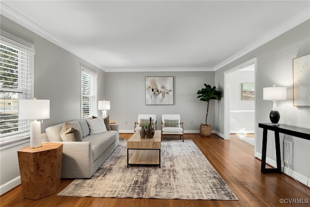 living room with baseboards, wood finished floors, and ornamental molding