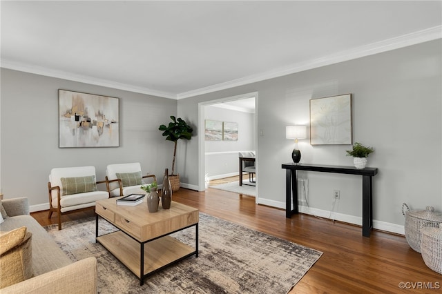 living room featuring ornamental molding, baseboards, and wood finished floors